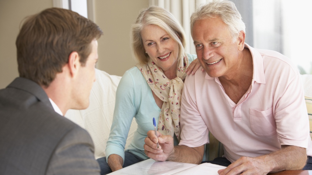Old couple signing paperwork