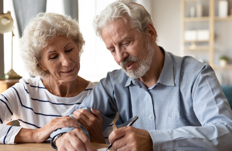 old couple signing paperwork