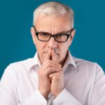 Older man with glasses and steepled fingers_s