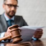 Judge sitting at a desk behind a gavel_s