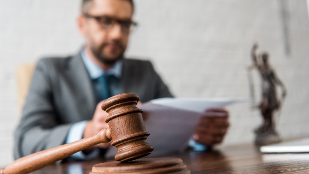 Judge sitting at a desk behind a gavel