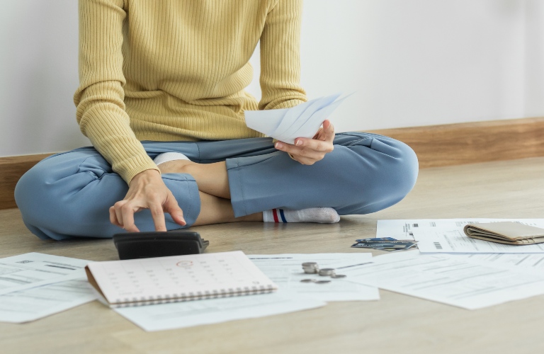Woman sitting on the floor figuring stuff out
