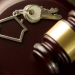 gavel on a desk with house keys_s