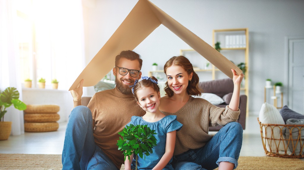 family under a cardboard roof in their home