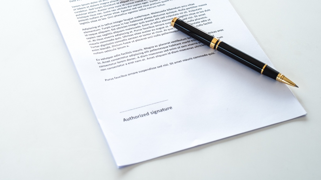 A document with a pen on top