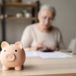 Toy,Pink,Piggy,Bank,On,Work,Table,Of,Senior,Tenant,