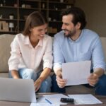 Happy couple doing domestic paperwork