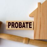 Probate word on a wooden block on the background of a house and gavel_s