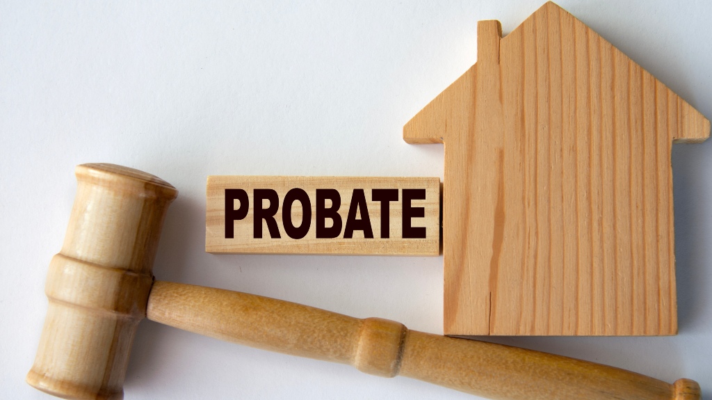 Probate word on a wooden block on the background of a house and gavel