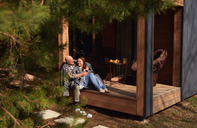 Couple in love resting on cottage veranda