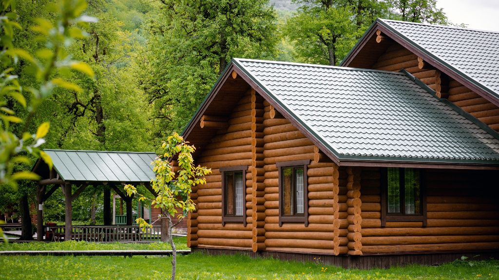 Horizontal photo of wooden house in green forest