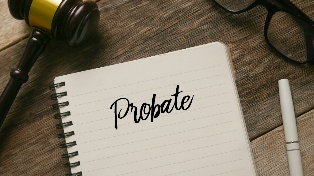 gavel,glasses,pen and notebook with word Probate