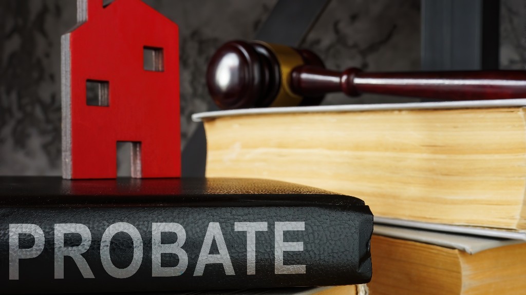 Probate law book and model of house on it