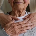 woman hugging mother from behind holding hands_s