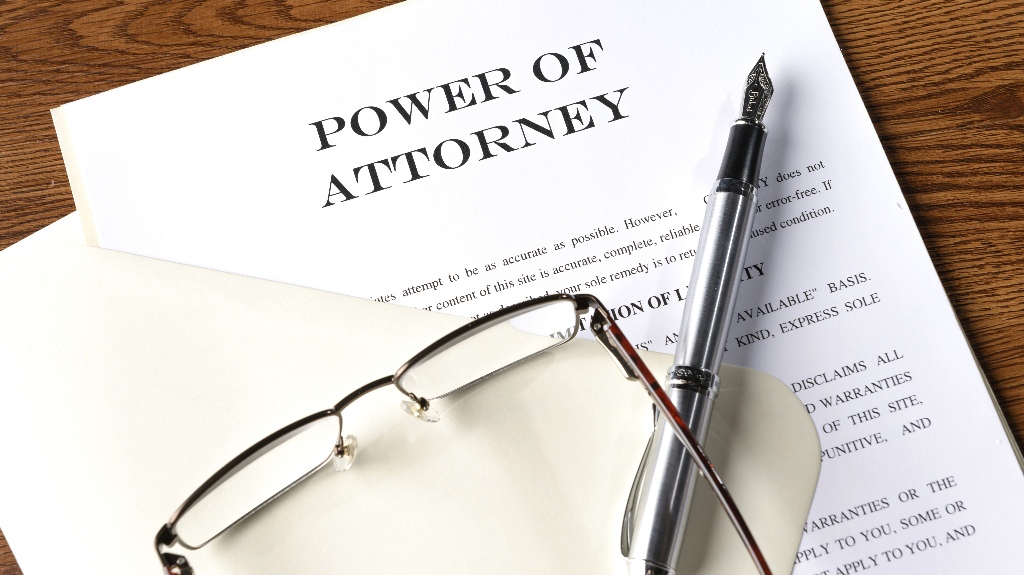 Power of Attorney document and pen