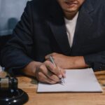 lawyer working with contract document and wooden gavel at desk in courtroom_s