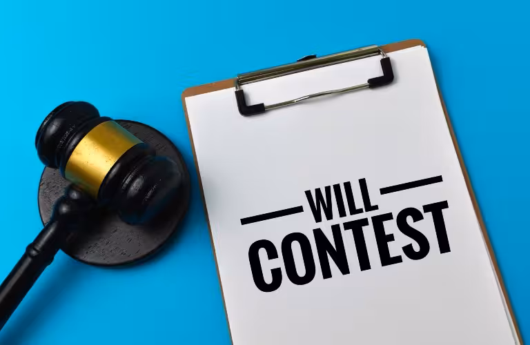 Clipboard with the text "WILL CONTEST" beside a black and gold judge's gavel on a blue background.